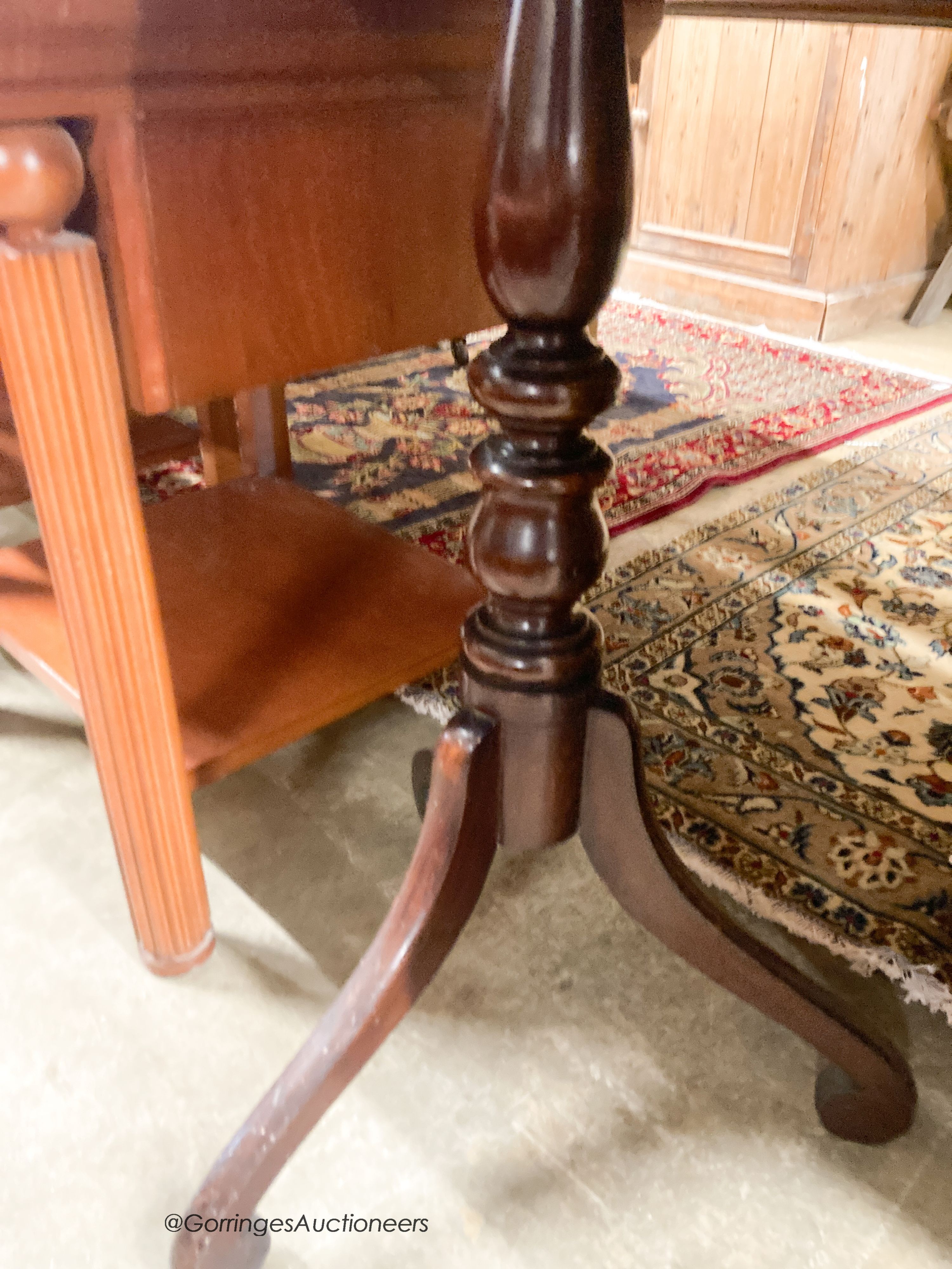 An early 19th century mahogany games top tripod table, width 51cm, depth 51cm, height 77cm